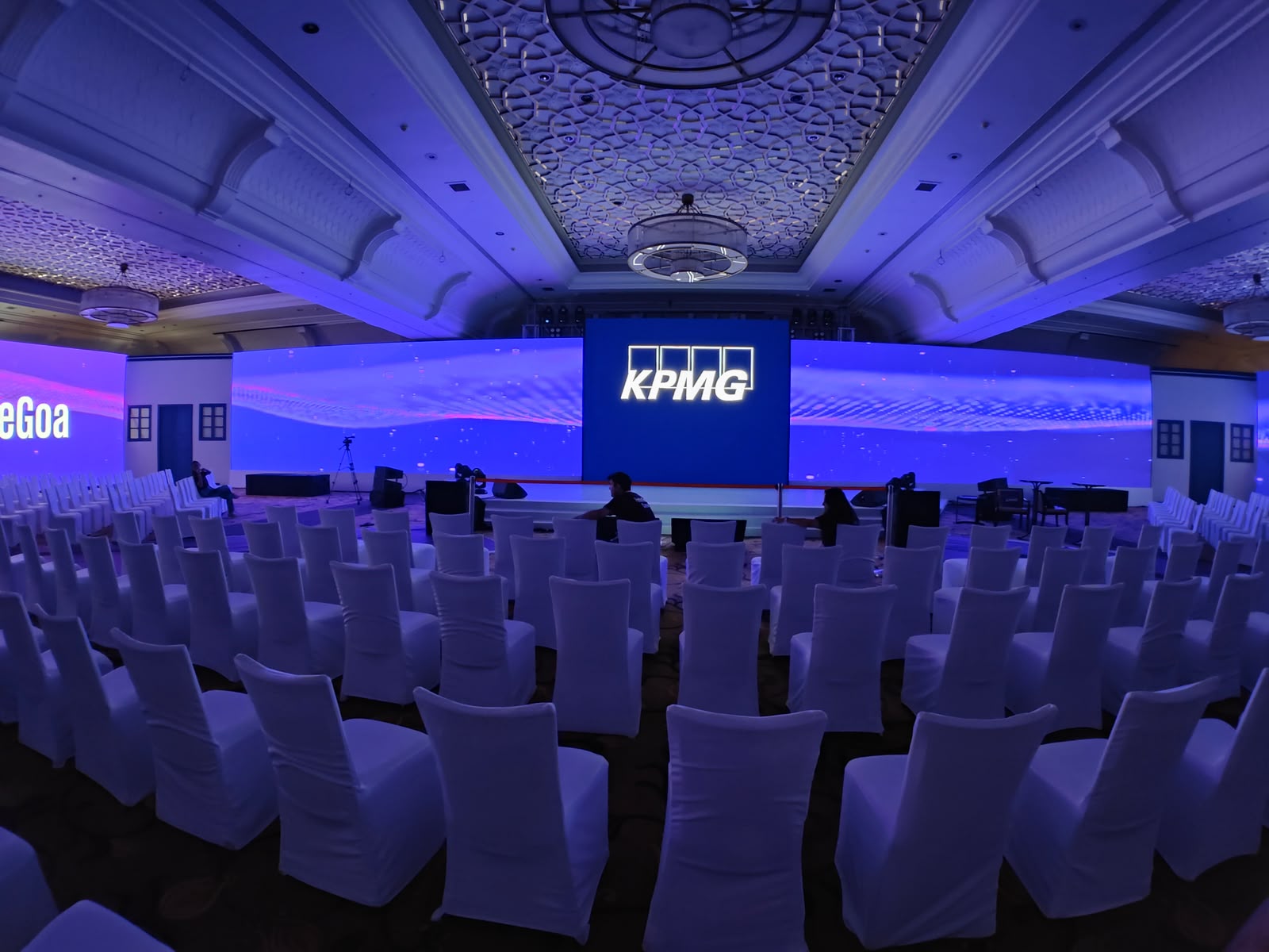 KPMG Feste Goa wide curved LED wall backdrop with blue uplighting in ballroom