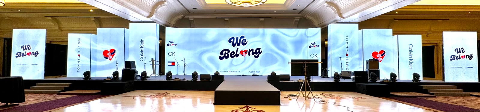 Tommy Hilfiger and Calvin Klein We Belong ballroom stage with wide LED wall and branded side pillars