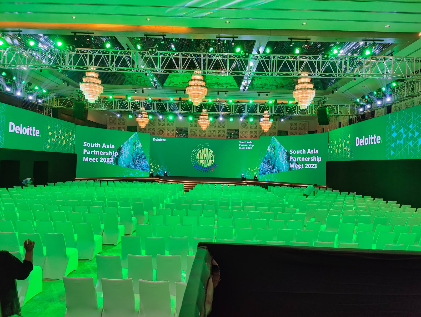 Deloitte South Asia Partnership Meet 2023 main stage wide with chandeliers and truss lighting