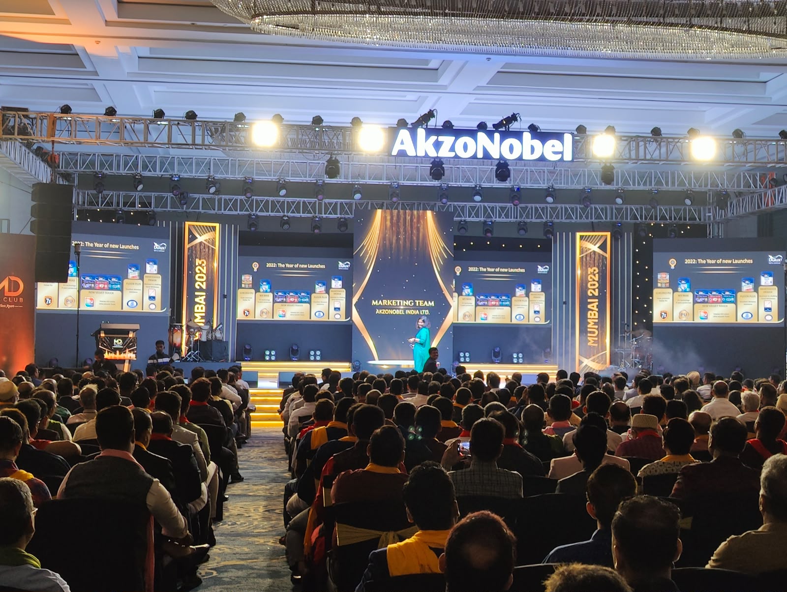 AkzoNobel Marketing Team event Mumbai 2023 with wide LED walls, chandeliers and packed banquet audience